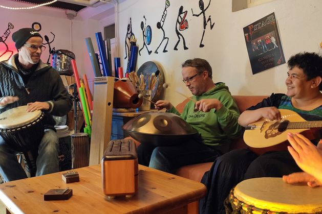 Das Bild zeigt drei Personen beim Musizieren mit akustischen Instrumenten im Therapiebereich des Musikraums in Grauhöft.